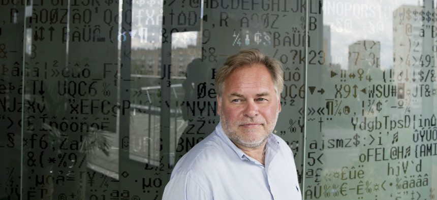 Eugene Kaspersky, Russian antivirus programs developer and chief executive of Russia's Kaspersky Lab, stands in front of a window decorated with programming code's symbols at his company's headquarters in Moscow, Russia, Saturday, July 1, 2017. 