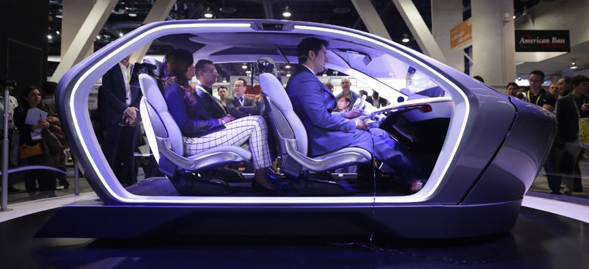 how attendees sit in the Chrysler Portal self-driving concept car at CES International Thursday, Jan. 5, 2017, in Las Vegas.