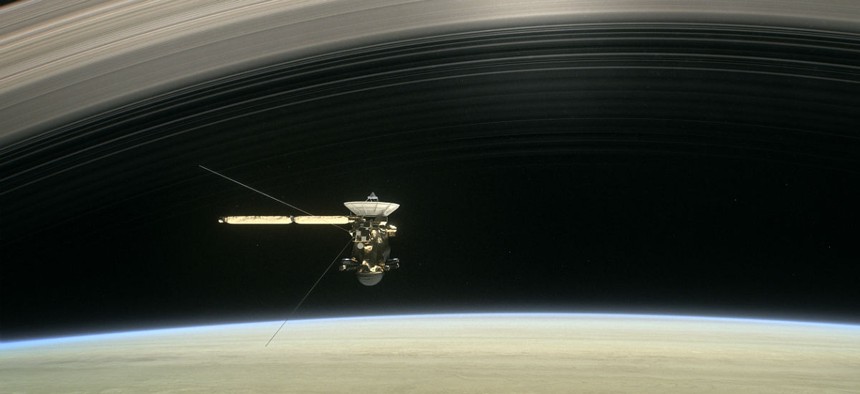 This image made available by NASA in April 2017 shows a still from the short film "Cassini's Grand Finale," with the spacecraft diving between Saturn and the planet's innermost ring.