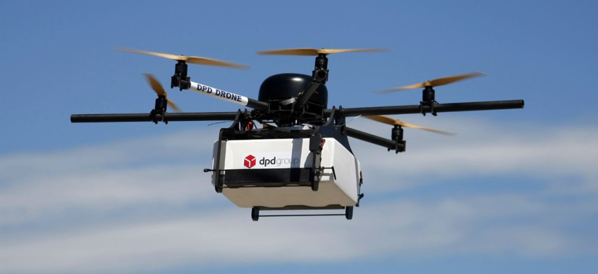 A DPD Geopost prototype drone files carrying a parcel flies during a test flight in Pourrieres, southern France, June 23, 2015. 