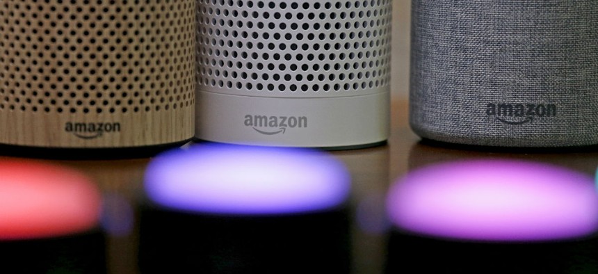 Amazon Echo and Echo Plus devices, behind, sit near illuminated Echo Button devices during an event announcing several new Amazon products by the company, Wednesday, Sept. 27, 2017, in Seattle.