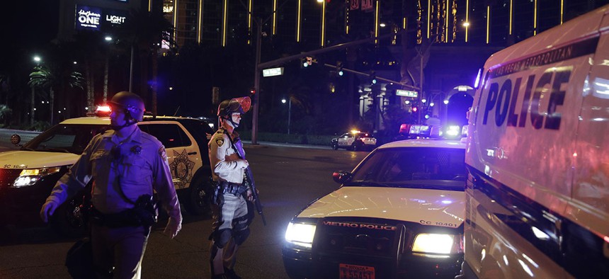 Police officers stand along the Las Vegas Strip outside the Mandalay Bay resort and casino during a deadly shooting near the casino, Sunday, Oct. 1, 2017, in Las Vegas.