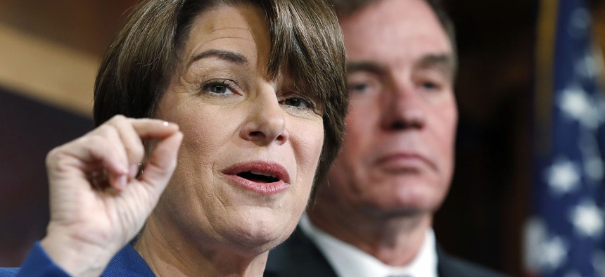 Sen. Amy Klobuchar, D-Minn., left, and Sen. Mark Warner, D-Va.