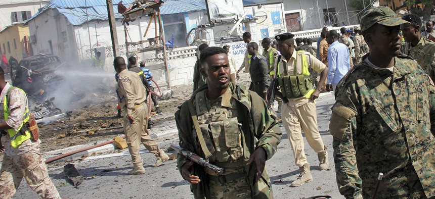 Somali security forces gather at the scene of a suicide car bomb attack on a police station in Mogadishu, Somalia Thursday, June 22, 2017.
