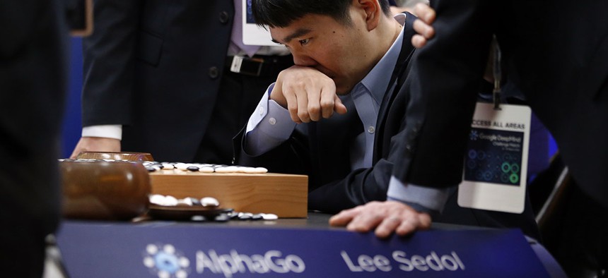 South Korean professional Go player Lee Sedol reviews the match after finishing the final match of the Google DeepMind Challenge Match against Google's artificial intelligence program, AlphaGo.