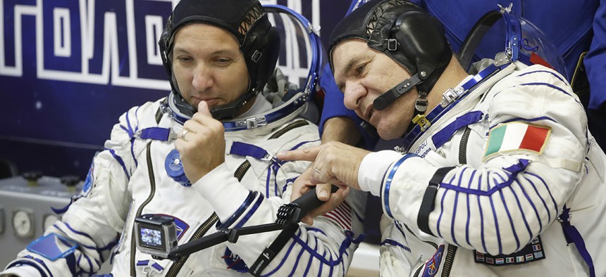 U.S. astronaut Randy Bresnik , left, and Italian astronaut Paolo Nespoli members of the main crew of the expedition to the International Space Station (ISS), look at a camera prior the launch of Soyuz MS-05 space ship.