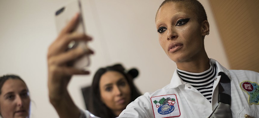 Model Adwoa Aboah takes a selfie backstage prior to the Versus Spring/Summer 2018 runway show at London Fashion Week in London, Sunday, Sept. 17, 2017.