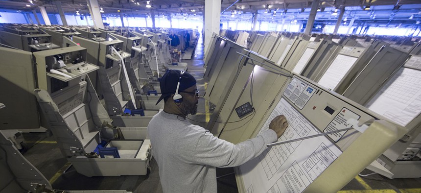A technician works to prepare voting machines to be used in the upcoming 2016 election in Philadelphia.