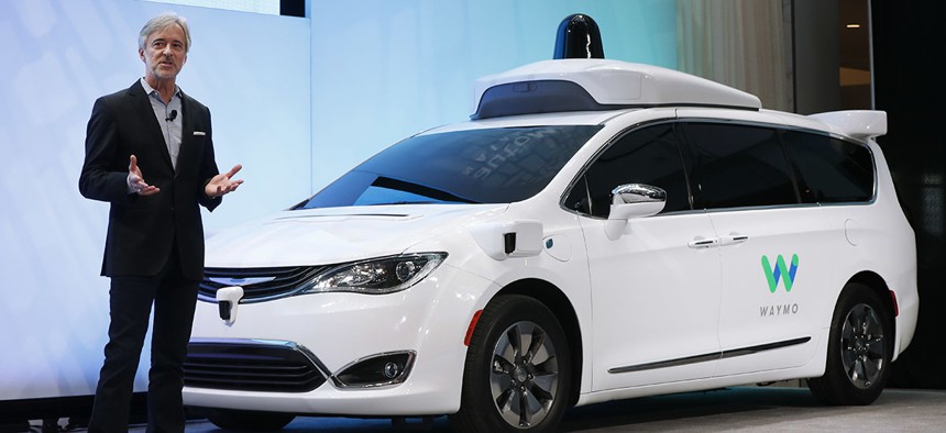 John Krafcik, CEO of Waymo, the autonomous vehicle company created by Google's parent company, Alphabet, introduces a Chrysler Pacifica hybrid outfitted with Waymo's own suite of sensors and radar.