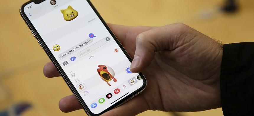 An Apple employee demonstrates the animoji feature of the new iPhone X at the Apple Union Square store Friday, Nov. 3, 2017.