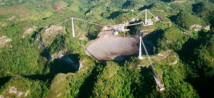 The world's largest radio telescope is seen from the air in this Wednesday, March 26, 2003 photo at the Arecibo Observatory, Puerto Rico.