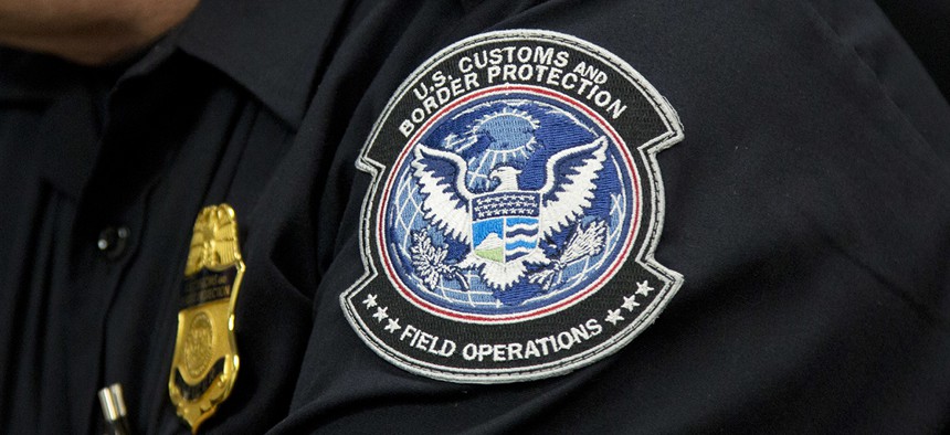 A customs agent wears a patch for the U.S. Customs and Border Protection agency, which is a part of the Department of Homeland Security, Friday, Oct. 27, 2017, at John F. Kennedy International Airport in New York.