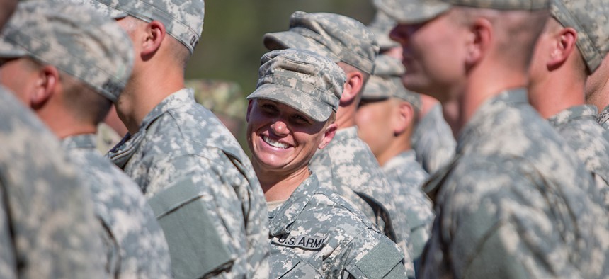 Maj. Lisa Jaster, center, stands in formation with other Rangers during an Army Ranger school graduation ceremony, Friday, Oct. 16, 2015, in Fort Benning, Ga. Jaster, who is the first Army Reserve female to graduate the Army's Ranger School.
