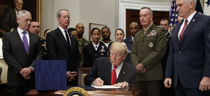 President Donald Trump signs the National Defense Authorization Act for Fiscal Year 2018, in the Roosevelt Room of the White House, Tuesday, Dec. 12, 2017.