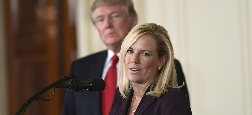 President Donald Trump, left, listens as Kirstjen Nielsen, right, speaks in the East Room of the White House in Washington after Trump announced that she is his choice to be the next Homeland Security Secretary. 