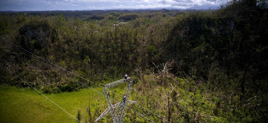 Electrical lineman work on transmission towers in Barceloneta, Puerto Rico.