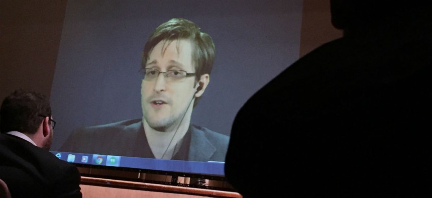 Edward Snowden speaks via video conference to people in the Johns Hopkins University auditorium February 2016.