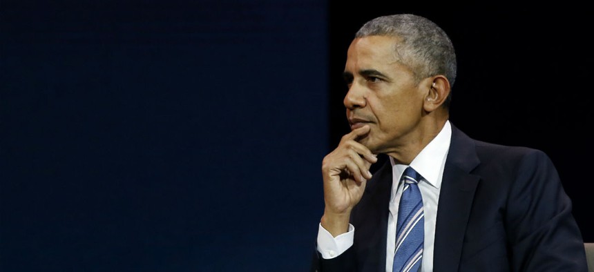 Former President Barack Obama pauses as he gives a speech in Paris, Dec. 2.