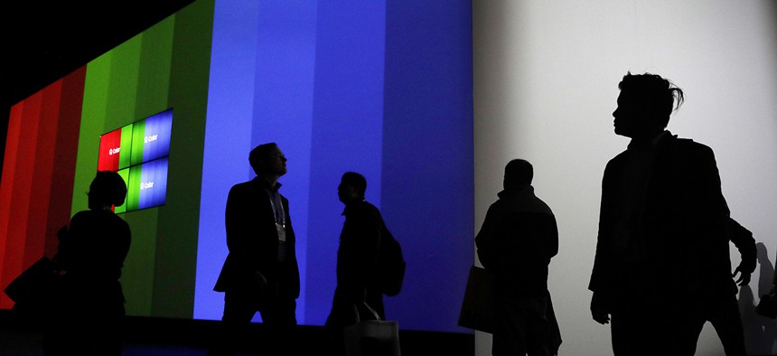 Attendees walk through the Samsung booth during CES International, Friday, Jan. 6, 2017, in Las Vegas.