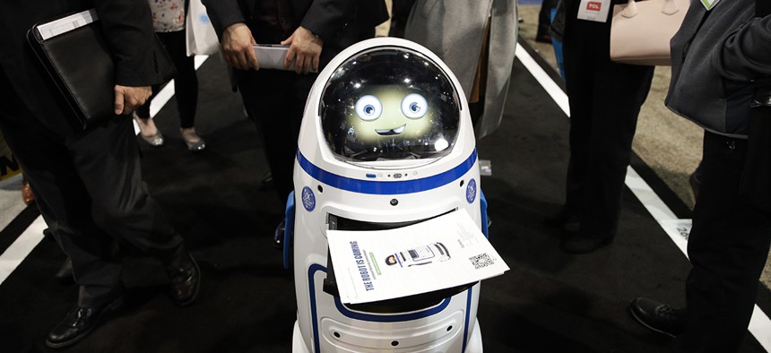 Evolver's Fabo E01 service robot carries flyers at CES International, Wednesday, Jan. 10, 2018, in Las Vegas.