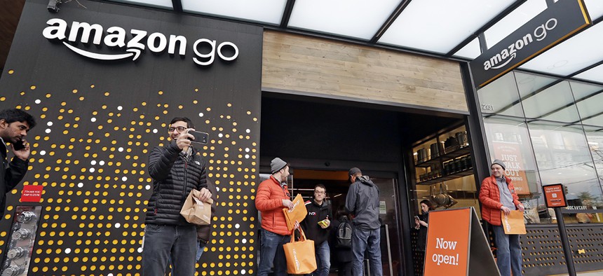 People stand outside an Amazon Go store Monday, Jan. 22, 2018, in Seattle. People stand outside an Amazon Go store Monday, Jan. 22, 2018, in Seattle. 