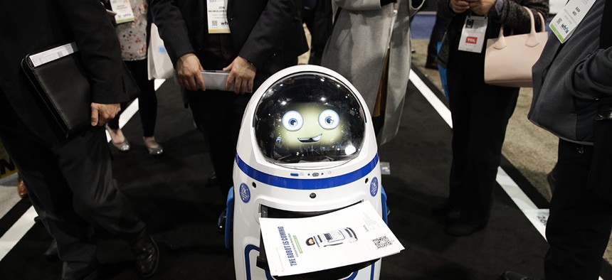 Evolver's Fabo E01 service robot carries flyers at CES International, Wednesday, Jan. 10, 2018, in Las Vegas. 