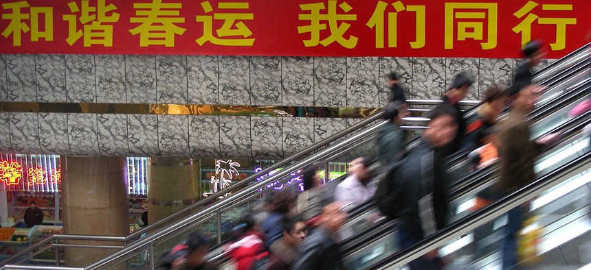 Passengers take moving staircases to waiting halls of a railway station in Zhengzhou, China.