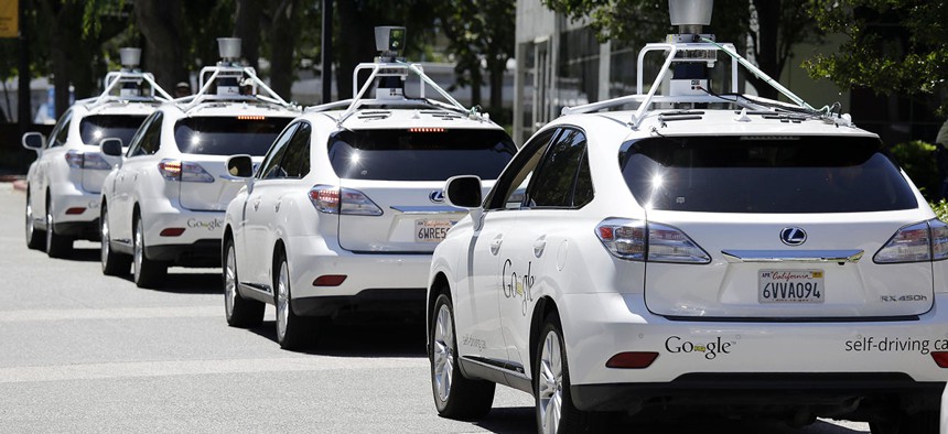 A row of Google self-driving Lexus cars at a Google event outside the Computer History Museum in Mountain View, Calif.