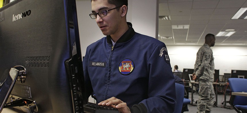 In this Feb. 20, 2013 photo, a cadet works at a large computer display inside a classroom at the Center for Cyberspace Research, where cyber warfare is taught, at the U.S. Air Force Academy, in Colorado Springs.