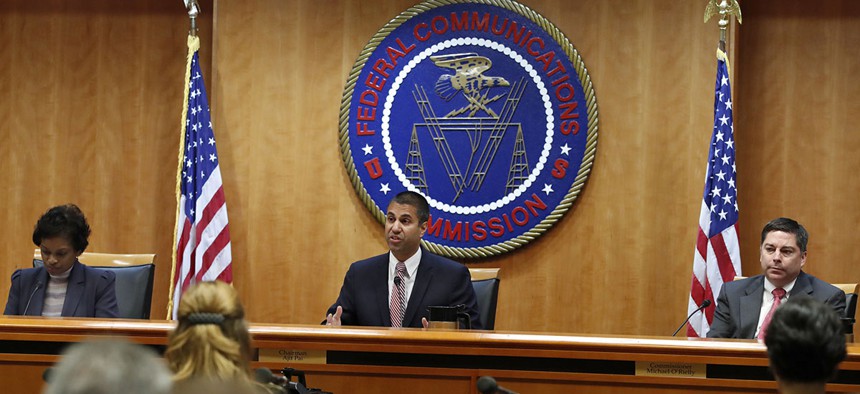 FCC Chairman Ajit Pai, center, sits next to Commissioner Mignon Clyburn, left, and Commissioner Michael O'Rielly. 