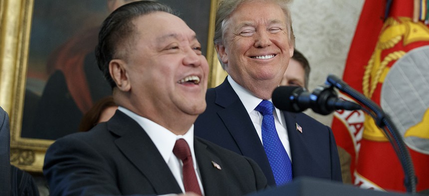 President Donald Trump smiles at Broadcom CEO Hock Tan during an event to announce that the company is moving its global headquarters to the United States, Thursday, Nov. 2, 2017.