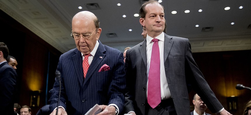 Commerce Secretary Wilbur Ross, center left, and Labor Secretary Alex Acosta, right, arrive before a Senate Committee on Commerce, Science, & Transportation hearing on infrastructure on Capitol Hill.
