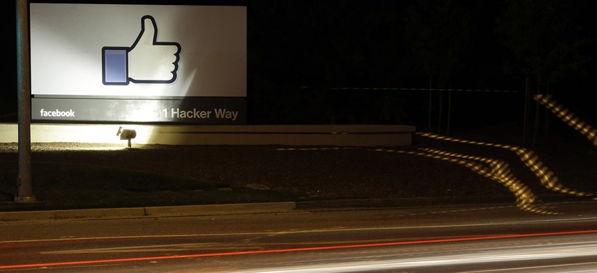 The Facebook "like" symbol is on display on a sign outside the company's headquarters in Menlo Park, Calif.