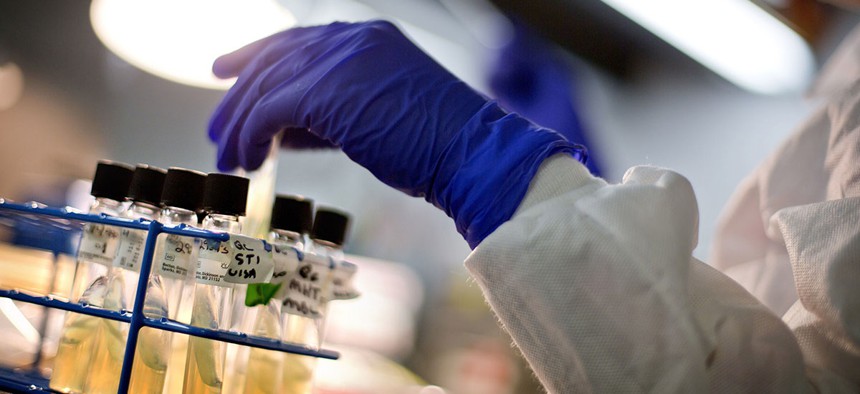 A microbiologist works with tubes of bacteria samples in the Infectious Disease Laboratory at the CDC in Atlanta.