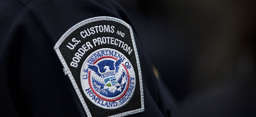 A customs agent wears a patch for the U.S. Customs and Border Protection agency.