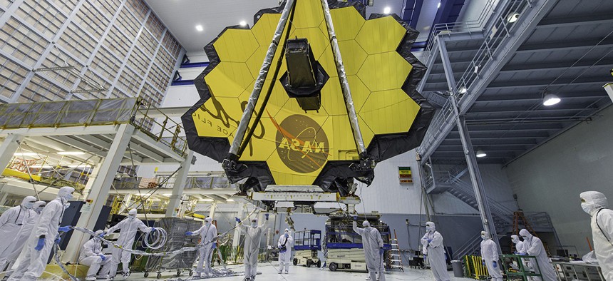 NASA technicians lift the mirror of the James Webb Space Telescope using a crane at the Goddard Space Flight Center in Greenbelt, Md. 