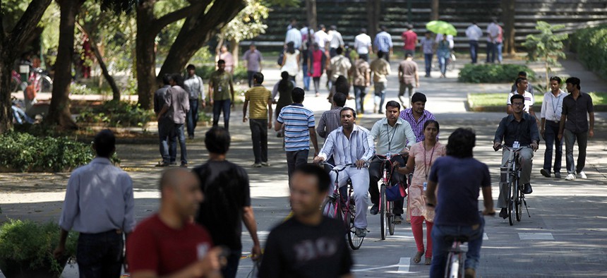 Infosys Technologies employees move through the headquarters during a break in Bangalore, India.