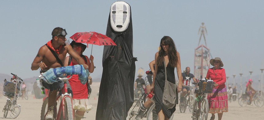 Burning Man participants walk on the playa at the Black Rock Desert near Gerlach, Nev. 