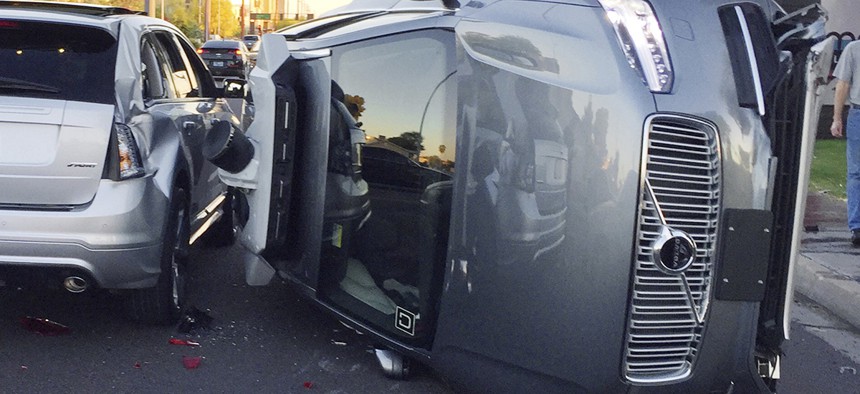 This March 24, 2017, photo provided by the Tempe Police Department shows an Uber self-driving SUV that flipped on its side in a collision in Tempe, Ariz.