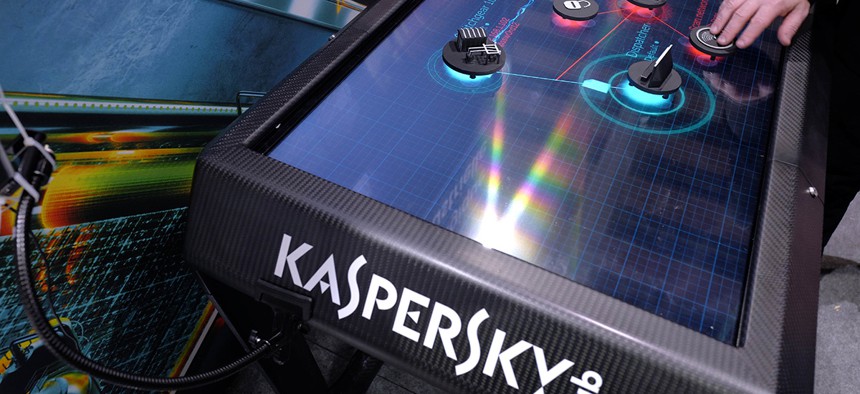 A man uses an electronic demonstration table at the Kaspersky Lab stand during the International Cybersecurity forum in Lille, northern France, Tuesday Jan. 23, 2018. 