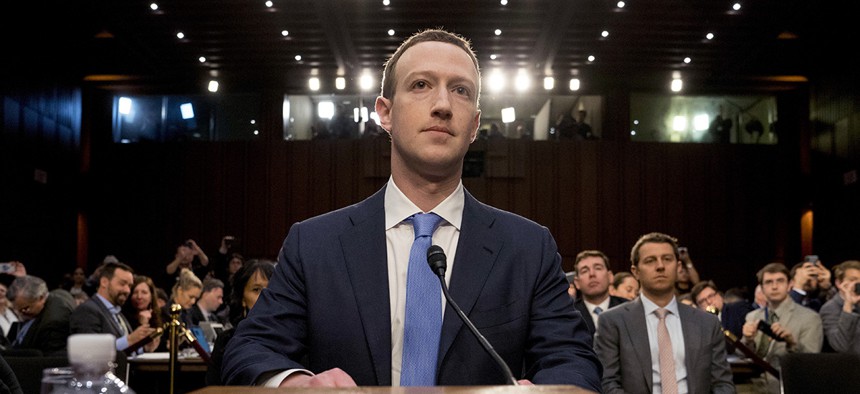 Facebook CEO Mark Zuckerberg arrives to testify before a joint hearing of the Commerce and Judiciary Committees on Capitol Hill in Washington, Tuesday, April 10, 2018.