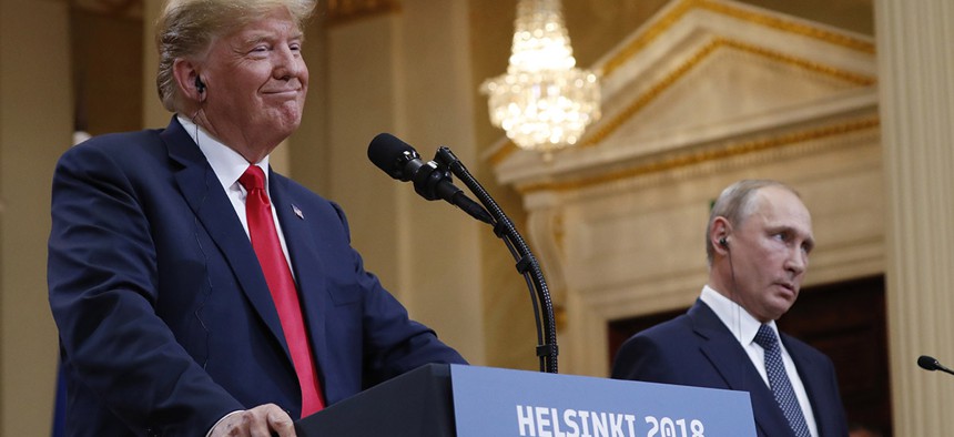 U.S. President Donald Trump, left, smiles beside Russian President Vladimir Putin during a press conference after their meeting at the Presidential Palace in Helsinki, Finland, Monday, July 16, 2018. 