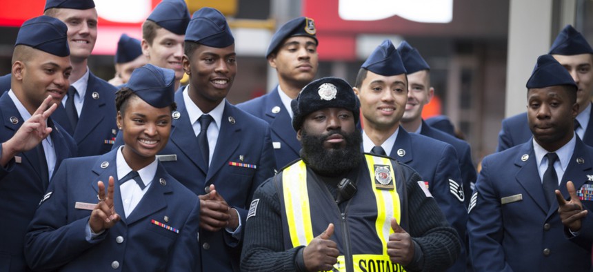A group of U.S. Air Force personnel take a picture with a Times Square Public Safety Officer after the annual Americas Parade up 5th Avenue on Veterans Day in Manhattan in 2015.