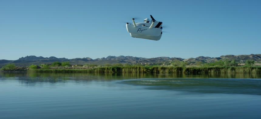 A Flyer personal aircraft cruises above a body of water.