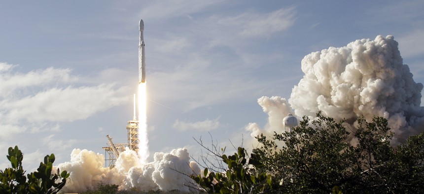 A Falcon 9 SpaceX heavy rocket lifts off from pad 39A at the Kennedy Space Center in Cape Canaveral, Fla., Tuesday, Feb. 6, 2018. 