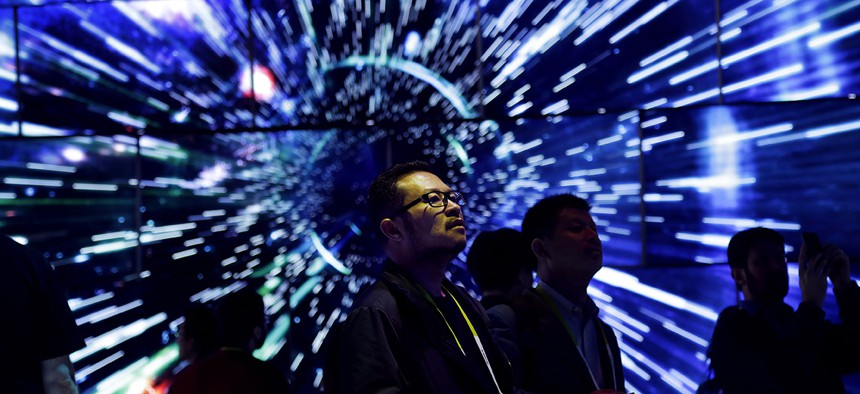 Bao Truong looks at a display of Samsung SUHD Quantum dot display TVs at the Samsung booth during CES International, Friday, Jan. 8, 2016, in Las Vegas. 