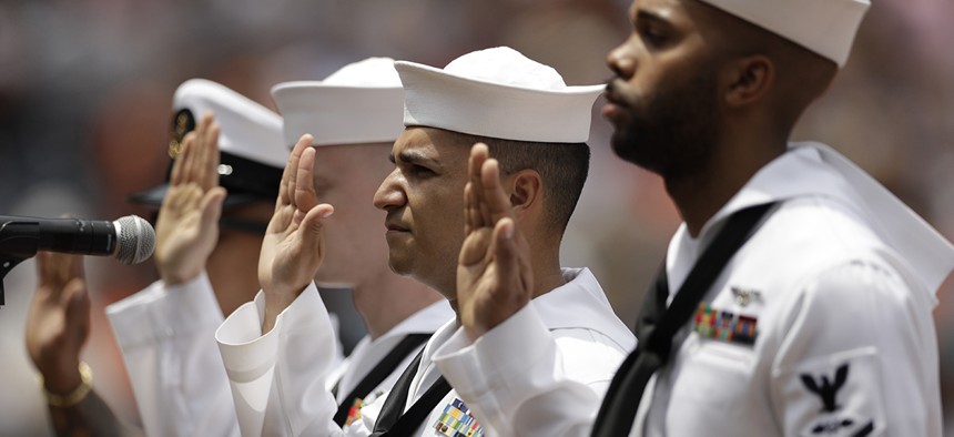 Navy sailors from the USS Makin Island take part in a re-enlistment ceremony in San Diego.