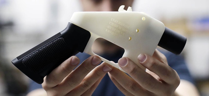 Cody Wilson, with Defense Distributed, holds a 3D-printed gun called the Liberator at his shop, Wednesday, Aug. 1, 2018, in Austin, Texas. 