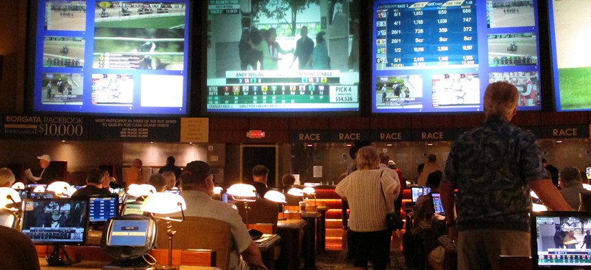 Bettors wait to make wagers on sporting events at the Borgata casino in Atlantic City, N.J.,