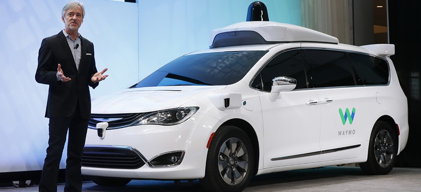 John Krafcik, CEO of Waymo, introduces a Chrysler Pacifica hybrid outfitted with Waymo's own suite of sensors and radar, at the North American International Auto Show in Detroit.